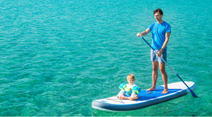 man paddleboarding with baby